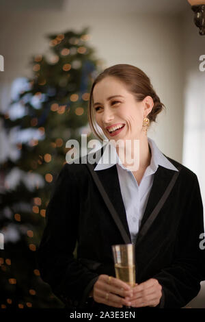Smiling mid-adult woman holding a champagne flute. Stock Photo