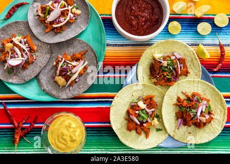 Fresh Mexican tacos on table with chili sauce Stock Photo