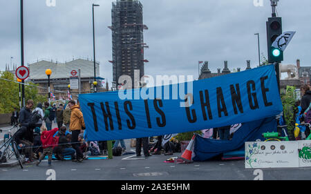 Westminster Bridge, London UK. 7th October 2019. Extinction rebellion climate change activists gather outside St Thomas' Hospital and Westminster bridge creating traffic disruption on major roads around Westminster.  This was the first day of protests which are planned accross London for the next fortnight to raise awareness of global climate change.  Celia McMahon/Alamy Live News. Credit: Celia McMahon/Alamy Live News