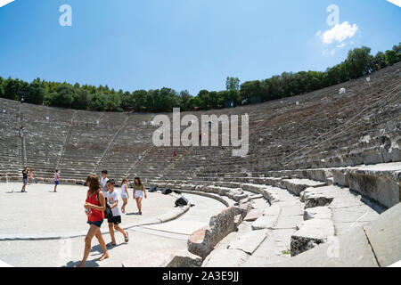 EPIDAURUS GREECE - JULY 19 2019; Wide angle image of Ancient Epidaurus theatre with tourists on stage and in the stone seating. Stock Photo