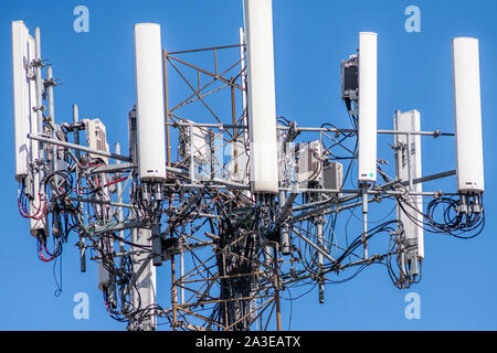 Close up of cell tower against blue sky Stock Photo