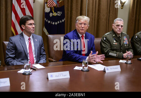 Washington, United States. 07th Oct, 2019. United States President Donald J. Trump answers a reporter's question as he participates in a briefing with senior military leaders in the Cabinet Room of the White House in Washington, DC on Monday, October 7, 2019. At left is United States Secretary of Defense Dr. Mark T. Esper, left, and at right is United States Army General Mark A. Milley, Chairman of the Joint Chiefs of Staff. Photo by Ron Sachs/UPI Credit: UPI/Alamy Live News Stock Photo