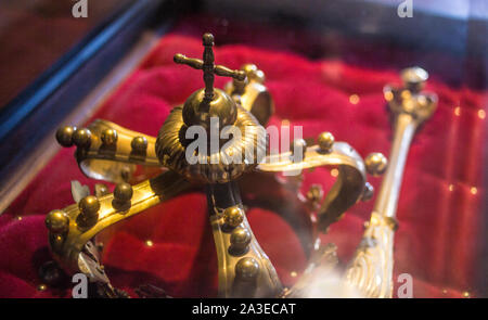 low key image of beautiful queen/king Luxury crown golden jewelry on  red satin . vintage filtered. fantasy medieval period  jewels. Image in Romanian Stock Photo