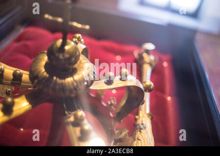 low key image of beautiful queen/king Luxury crown golden jewelry on  red satin . vintage filtered. fantasy medieval period  jewels. Image in Romanian Stock Photo