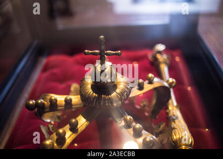 low key image of beautiful queen/king Luxury crown golden jewelry on  red satin . vintage filtered. fantasy medieval period  jewels. Image in Romanian Stock Photo