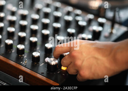Hand of a DJ who mixes music on a DJ controller. Selective focus. Stock Photo