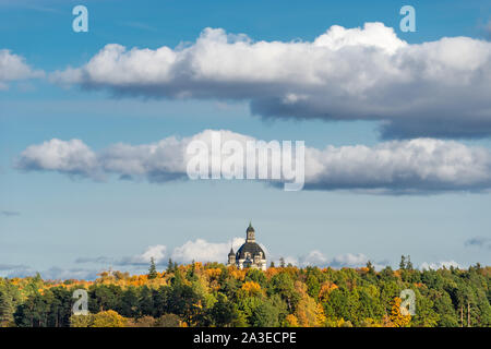 The dome of Church of the Visitation in the monastery of Pažaislis in Kaunas on a sunny autumn day. View from behind Kaunas lagoon from the dam Stock Photo
