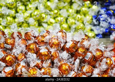 NEW YORK CITY, NY -4 OCT 2019- View of lots of Lindt truffle chocolate balls wrapped in colorful foil for sale at a Lindt candy store in New York. Stock Photo