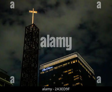 Okura Hotel in the night sky of Tokyo with an illuminated church cross in Tokyo, Japan Stock Photo