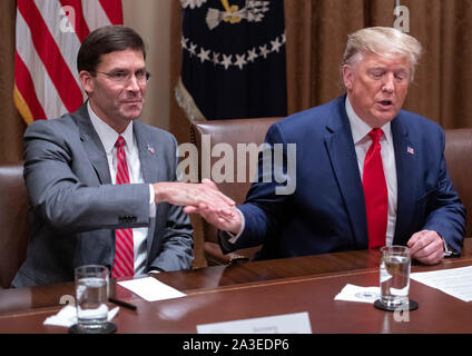 United States President Donald J. Trump, right, shakes hands with US Secretary of Defense Dr. Mark T. Esper, left, as he participates in a briefing with senior military leaders in the Cabinet Room of the White House in Washington, DC on Monday, October 7, 2019.Credit: Ron Sachs/Pool via CNP | usage worldwide Stock Photo