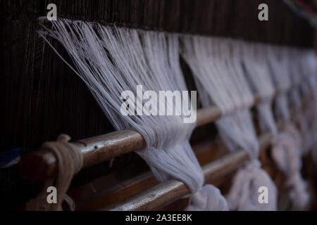 Weaving with an artisanal spinning machine in a Mexican town Stock Photo