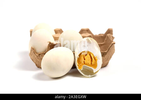 Salted duck's egg on white background with one of it being cut half Stock Photo