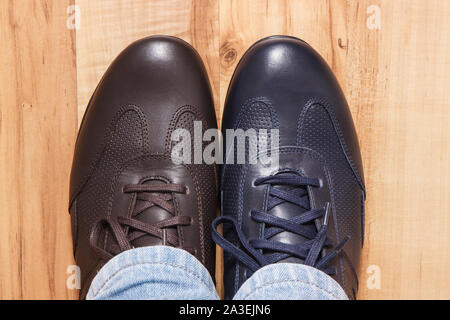 Elegant stylish comfortable navy blue and brown shoes for men on board Stock Photo