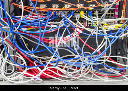 Bangkok Thailand, June 25, 2019:- The Cable Network in Server room A bad case of cable spaghetti, The worst cable mess, concept Cable management Stock Photo