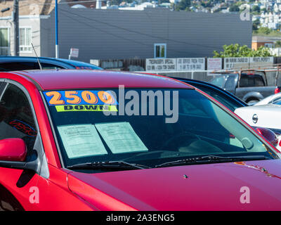 2500 down sign on red car on used car dealership Stock Photo