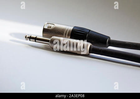 two audio cords for electric guitar lie on light background Stock Photo