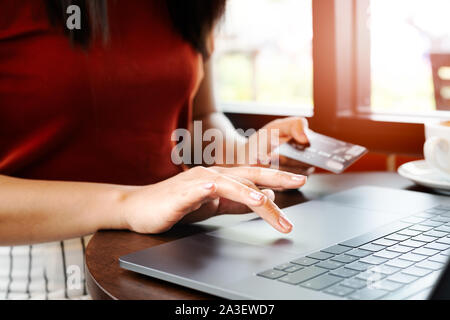 Woman hands holding credit card and using the laptop. Online shopping Stock Photo