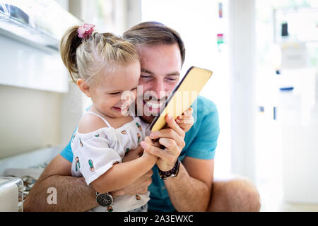 Happy joyful young father with his little daughter. Father and little kid having fun Stock Photo