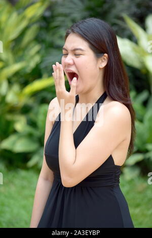 A Pretty Minority Woman Yawning Stock Photo