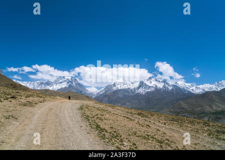 Trekker on the way from Muktinath to Kagbeni in Mustang district, Nepal Stock Photo