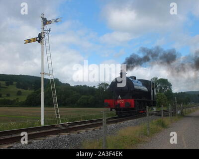 Steam locomotive run by Peak Rail, a heritage railway line passing a signal at Darley Dale near Matlock in Derbyshire Stock Photo