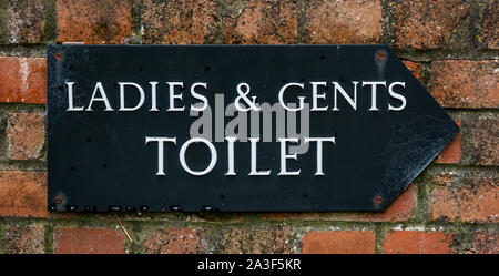 Old ladies and gents toilet sign Stock Photo