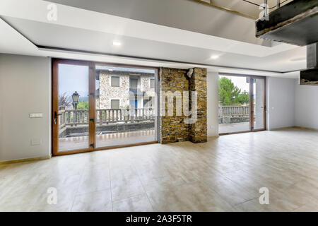 Empty and unfurnished brand new modern house. Beautiful big living room. Stock Photo