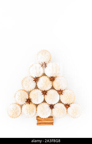 Top view of mince pie Christmas tree with star anise and cinnamon sticks isolated on white. Stock Photo