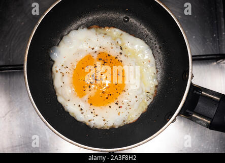 Fried egg with cracked black pepper Stock Photo