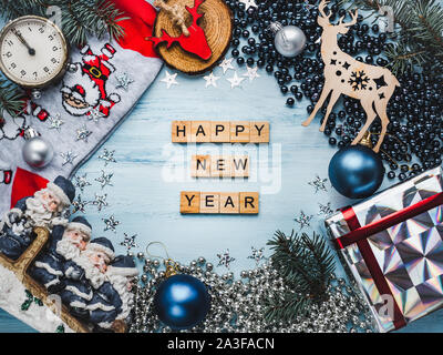 Wooden letters of the alphabet, Christmas ornament, gift boxes and Christmas tree branches. View from above, close-up, flat lay. Congratulations to lo Stock Photo