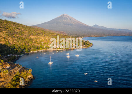 Sunrise over the Jemeluk bay in the Amed area with the famous Agung volcano in northeast Bali in Indonesia Stock Photo