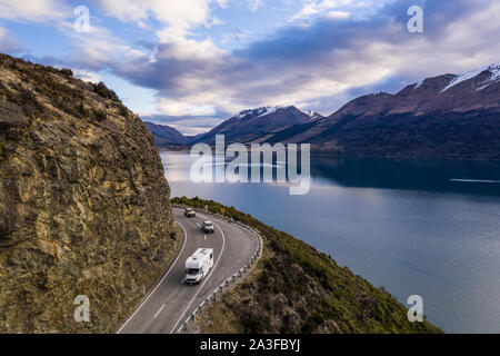 Camping car driving along the stunning lake Wakapitu between Queenstown and Glenorchy in New Zealand south island at sunset Stock Photo