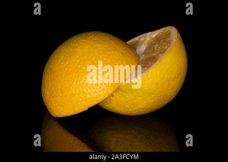 Group of two halves of fresh bright orange isolated on black glass Stock Photo