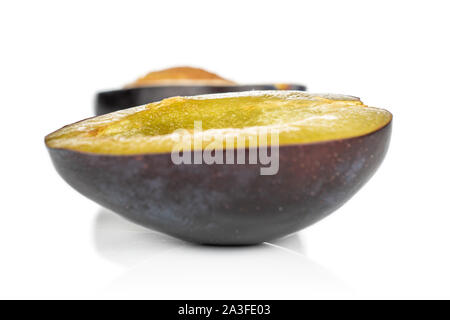 Group of two halves of fresh purple plum isolated on white background Stock Photo