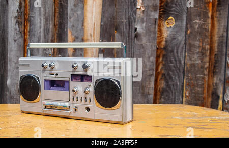 retro cassette player on wooden table outdoor closeup