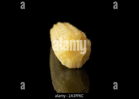 One whole baby yellow corn isolated on black glass Stock Photo