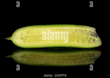 One half of mini green cucumber isolated on black glass Stock Photo