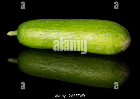 One whole mini green cucumber isolated on black glass Stock Photo