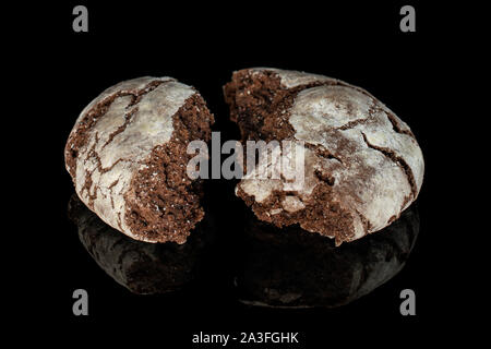 Group of two halves of baked chocolate brownie cookie isolated on black glass Stock Photo