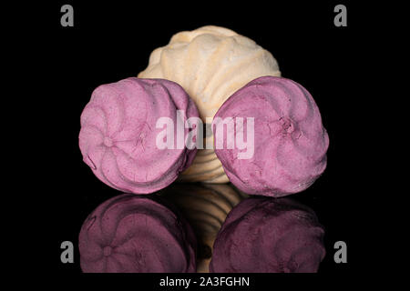 Group of three whole fresh pastel zefir isolated on black glass Stock Photo