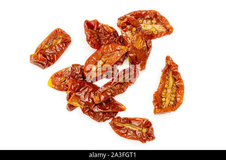Lot of slices of dry red cherry tomato flatlay isolated on white background Stock Photo