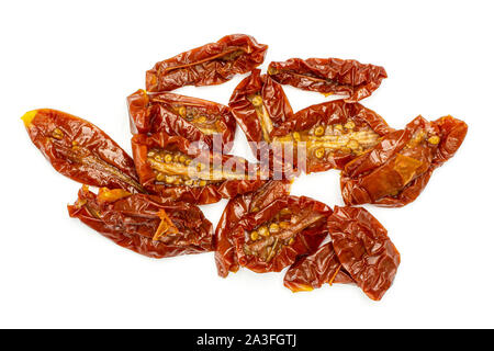 Lot of slices of dry red cherry tomato flatlay isolated on white background Stock Photo