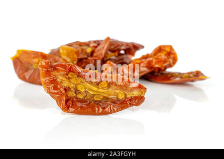 Lot of slices of dry red cherry tomato front focus isolated on white background Stock Photo