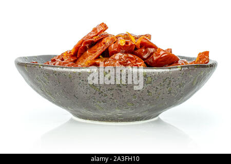 Lot of slices of dry red cherry tomato on grey ceramic plate isolated on white background Stock Photo