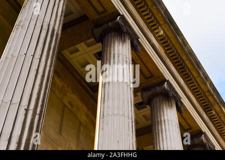 Columns on the exterior of a historic building with detailed stone work Stock Photo