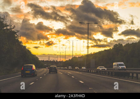 driving at dusk on a major road in central lane view from inside a car Stock Photo