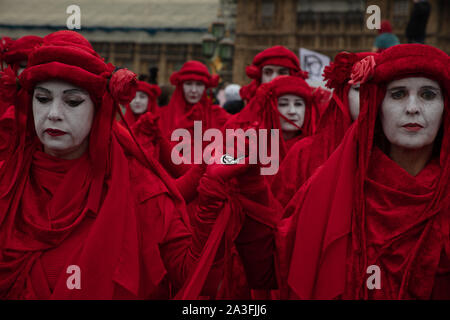 London, UK. 7th October 2019. Extinction Rebellion demonstrators dressed in red costumes during a two week long protest in London. Credit: Joe Kuis / Alamy News Stock Photo