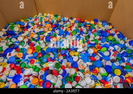 Plastic recycle. Sorting garbage. Waste recycling. Waste recycling plant. Colorful plastic bottle caps background. Colorful background of bottle caps. Recyclable waste concept. Material for processing Stock Photo