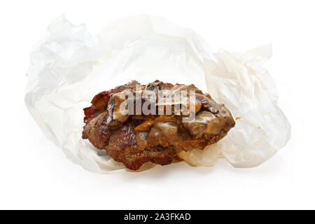 Grilled pork neck with mushrooms and cheese. Food on paper. Stock Photo