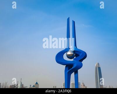December 2018 - Jinan, China: The large spring sculpture on Quancheng square and skyline of Jinan with the Greenland Puli center in the city Stock Photo